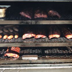 Various smoked meats on their way to deliciousness