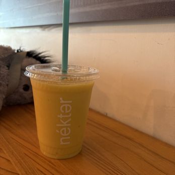 Nekter Juice Bar - Small Mango delighted with 2 scoops mango, 2 scoops pineapple, one banana, cashew milk, and green tea metabolism boost - Juice Bars & Smoothies Near Me - Scottsdale, Arizona Nekter Juice Bar - Small Mango delighted with 2 scoops mango, 2 scoops pineapple, one banana, cashew milk, and green tea metabolism boost - Juice Bars & Smoothies Near Me - Scottsdale, Arizona