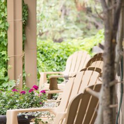 Arbor House Inn - Patio lounge chairs overlooking the river at the inn