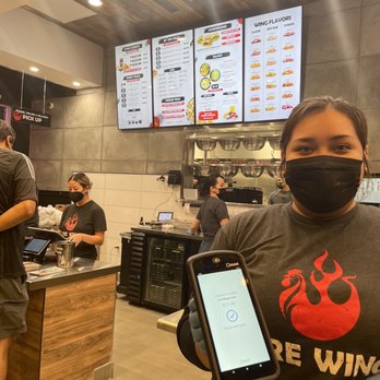 Fire Wings - Arianna Tackling the line with handheld POS - Chicken Shop Near Me - Irvine, California