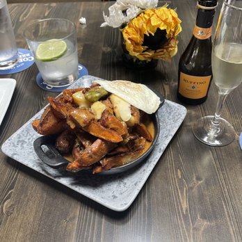 Bosscat Kitchen & Libations - Bosscat fries with egg over easy add on. Margarita and champagne - New American Near Me - Irvine, California