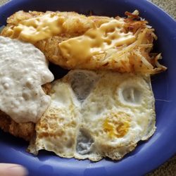 country corner restaurant - Country fried steak with gravy and 2 eggs over medium, hash browns with onions and cheese. Toast not in the pic.