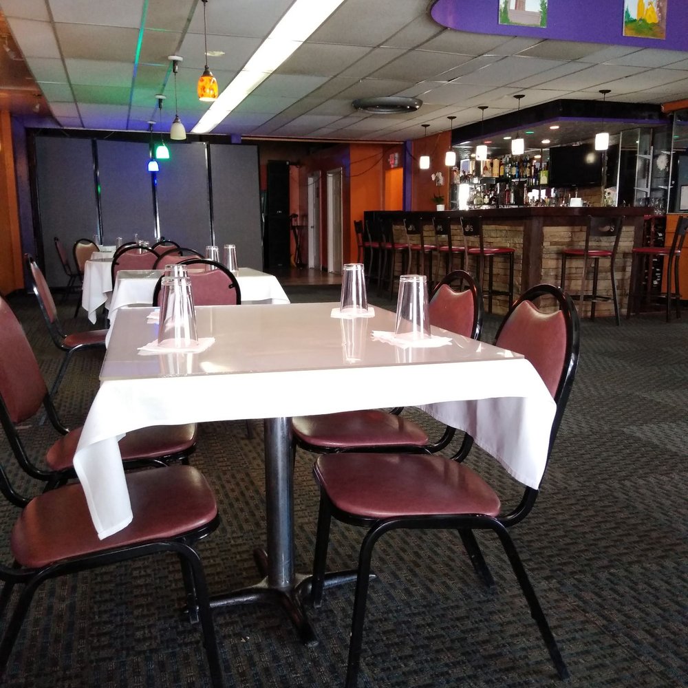 Africana Cafe - tables and chairs with white tablecloths - Ethiopian Near Me - Denver, Colorado