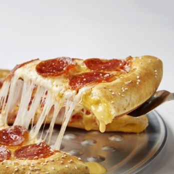 Pizza Inn - a slice of pepperoni pizza being lifted by a spatula - Italian Near Me - Jonesboro, Arkansas Pizza Inn - a slice of pepperoni pizza being lifted by a spatula - Italian Near Me - Jonesboro, Arkansas
