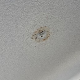 Hole made in kitchen ceiling with "patching" work her cleaner did