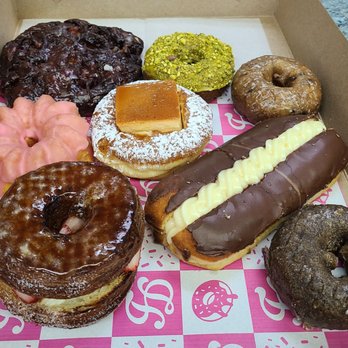 Friendly Donuts - Apple fritter,  Blueberry Cake, Flan donut, chocolate Creme, creme Brule dossant with fruit, chocolate cake , and a pink donut - Donuts Near Me - Orange, California