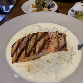 Belluccis Italian - Salmon cooked perfectly over angel hair and Alfredo sauce. - Italian Near Me - Midlothian, Texas