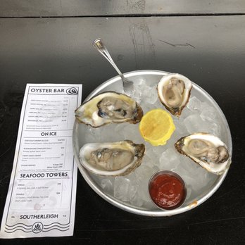 Southerleigh Oyster Bar - Two Gulf Coast Oysters to the left and two Lucky Lime to the right. - Seafood Near Me - San Antonio, Texas Southerleigh Oyster Bar - Two Gulf Coast Oysters to the left and two Lucky Lime to the right. - Seafood Near Me - San Antonio, Texas