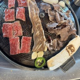 Boneless Short Ribs (left) comes with giant mushroom and onion Marinated Galbi (middle) bone in or out Wagyu Beef Belly (right) Boneless Short Ribs (left) comes with giant mushroom and onion Marinated Galbi (middle) bone in or out Wagyu Beef Belly (right)
