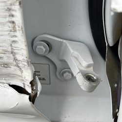 Caliber Collision - The B-pillar is visible and the passenger door hinge is almost off entirely on my Tesla Model Y