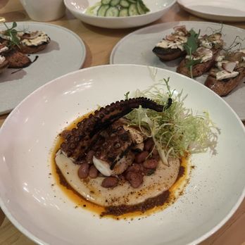 Mercantile - Grilled octopus, bone marrow toast in the background - New American Near Me - Denver, Colorado