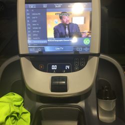 Anytime Fitness - Treadmill has its own television, phone charger, 2USB inputs for watching your own media if you want, and a headphone plug to watch DirecTV