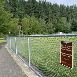 Lake Stevens Community Park - Walking path and fence with sign with length/distance of the walking path.