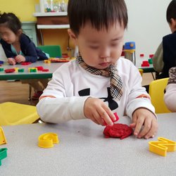 Shim's Playland Infant Daycare - Children playing play dough