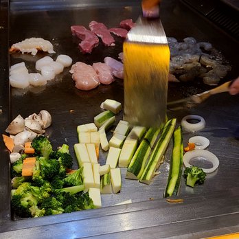 Little Buddha - a person cutting vegetables on a grill - Sushi Bars Near Me - West Nyack, New York Little Buddha - a person cutting vegetables on a grill - Sushi Bars Near Me - West Nyack, New York