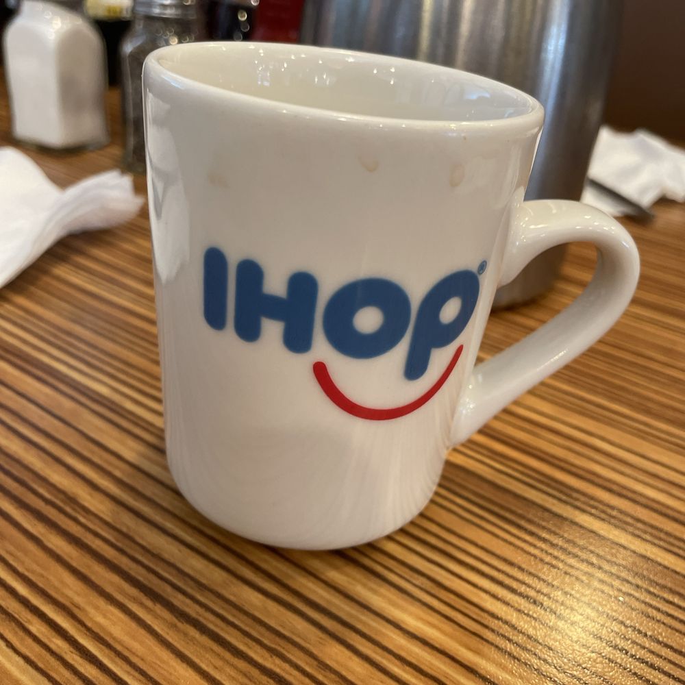 a white coffee cup with the word ihop written on it