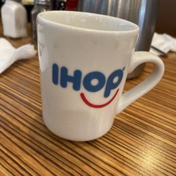 a white coffee cup with the word ihop written on it a white coffee cup with the word ihop written on it