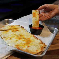 Stars and Strikes - Our flatbread smothered in our four-cheese blend and our secret spice, served with marinara