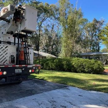 Gator Tree Service - a utility truck parked in front of a house - Tree Services Near Me Gator Tree Service - a utility truck parked in front of a house - Tree Services Near Me