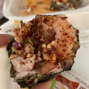 Mariscos El Tiburon - a hand holding a piece of food - Food Trucks Near Me - Stockton, California Mariscos El Tiburon - a hand holding a piece of food - Food Trucks Near Me - Stockton, California