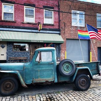 Sunny's Bar - an old truck parked on a cobblestone street - Bars Near Me - Brooklyn, New York