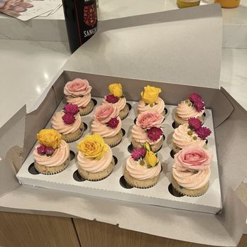 Ivory's Bake Shop - A dozen cupcakes with fresh flowers to match the wedding 2-tiered cake! - Custom Cakes Near Me - Los Angeles, California Ivory's Bake Shop - A dozen cupcakes with fresh flowers to match the wedding 2-tiered cake! - Custom Cakes Near Me - Los Angeles, California