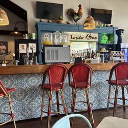 The Hush Cuban Kitchen - A photo of the bar and Cuban traditions of the roster, banjo and tiles on the side of the bar.