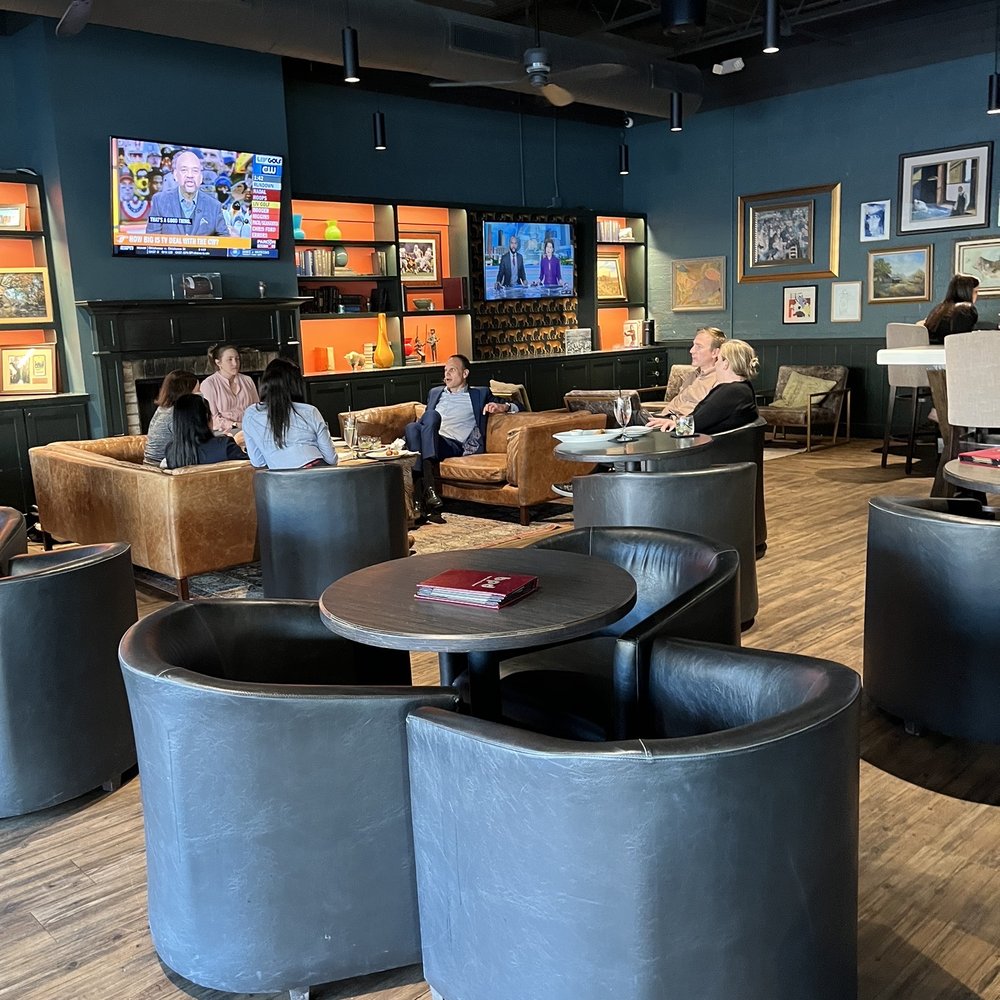 By Popular Demand - people sitting in the lounge area of a restaurant - Whiskey Bars Near Me - Houston, Texas