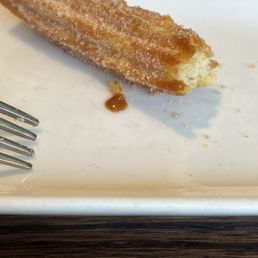 Churros that were so hard when I tried to pinch with the fork it jumped out of the plate ...