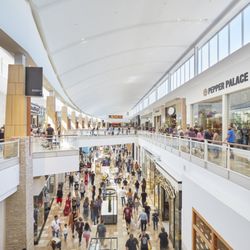 Chandler Fashion Center - Shoppers explore two levels of stores in a busy corridor at Chandler Fashion Center.