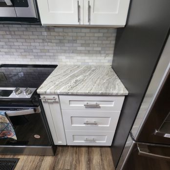 A&D Construction - Add a spice rack next to your stove for easy access when cooking! - Flooring Near Me