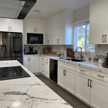 Levi & Sons Construction - a kitchen with white cabinets and marble countertops - General Contractors Near Me - Houston, Texas
