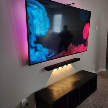 Servicified - 75-inch Sony with government lights and soundbar, wires hidden. - TV Mounting Near Me Servicified - 75-inch Sony with government lights and soundbar, wires hidden. - TV Mounting Near Me