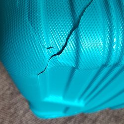 American Airlines - Cracked hard shell suitcase.