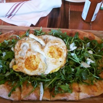 Pomegranate Bistro - Arugula Flatbread with truffle oil, cheese and eggs. - Breakfast & Brunch Near Me - Redmond, Washington Pomegranate Bistro - Arugula Flatbread with truffle oil, cheese and eggs. - Breakfast & Brunch Near Me - Redmond, Washington