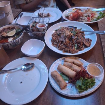 Koon Thai Kitchen - Clockwise: papaya salad, pad see ewe, spring rolls, tum yum noodle moo krob and chicken wings - Thai Near Me - San Diego, California