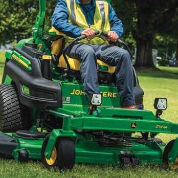 Jasmmig Services - a man sitting on a green lawn mower - Landscaping Near Me Jasmmig Services - a man sitting on a green lawn mower - Landscaping Near Me