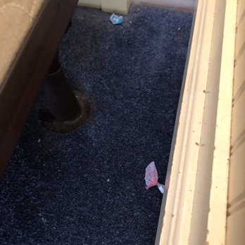 Surfside Resort - Dust and candy wrappers left beside the bed and night stand - Resorts Near Me - Miramar Beach, Florida