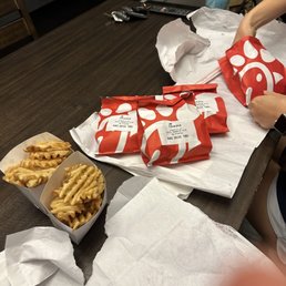 ows a woman putting a bag of fries into a bag ows a woman putting a bag of fries into a bag