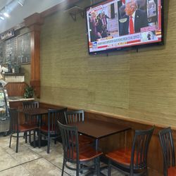 Italian Groceria Deli and Pizzeria - Interior with a convicted felon and abuser of women on tv