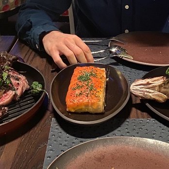 Garrison - Whole Grilled Branzino (right), Potatoes Au Gratin (middle) - New American Near Me - Austin, Texas Garrison - Whole Grilled Branzino (right), Potatoes Au Gratin (middle) - New American Near Me - Austin, Texas