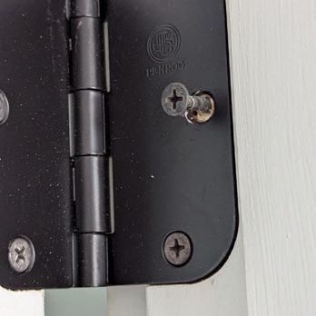 Monarch Custom Homes - Door hinge where drywall screws were used instead of the wood screws that came in the hinge pack I bought and provided. - Home Developers Near Me
