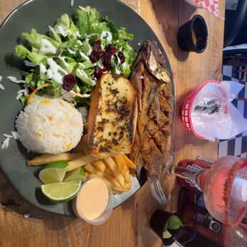 Marisqueando - In this picture, I had the fish salad, white rice, fries, and toasted bread and then you can see in the back. My boyfriend has a seafood. - Seafood Near Me - Fort Worth, Texas