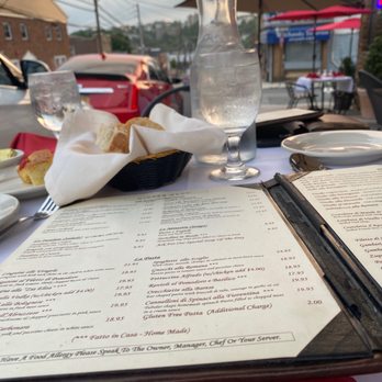 Reno's Trattoria - a table with a menu and a glass of water - Italian Near Me - Yonkers, New York