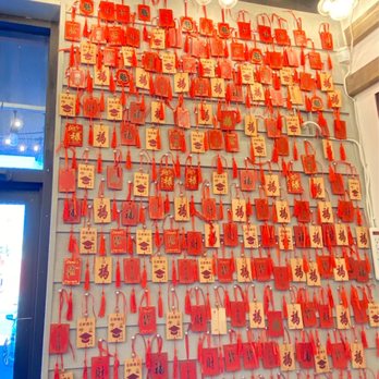 Noodles & Dumplings - A wall with red paper stickers. Green Onion Pancake Crab Cake - Noodles Near Me - El Paso, Texas Noodles & Dumplings - A wall with red paper stickers. Green Onion Pancake Crab Cake - Noodles Near Me - El Paso, Texas