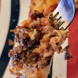 Highlander Pizza - A fork with a piece of The BBQ Steak Pizza.