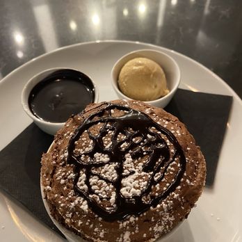 The Kitchen By Wolfgang Puck - Gluten free chocolate soufflé with chocolate sauce and salted caramel ice cream. - Italian Near Me - Grand Rapids, Michigan