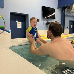 Chicago Blue Dolphins - Infant & toddler class -  baby leans forward to jump in with confidence