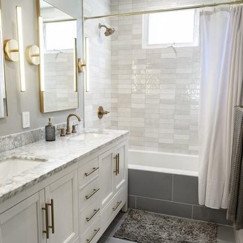 SF Construction - a bathroom with a marble countertop and white cabinets - General Contractors Near Me SF Construction - a bathroom with a marble countertop and white cabinets - General Contractors Near Me