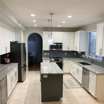 Redemption Renovations - a kitchen with white cabinets and stainless steel appliances - Cabinetry Near Me - Phoenix, Arizona